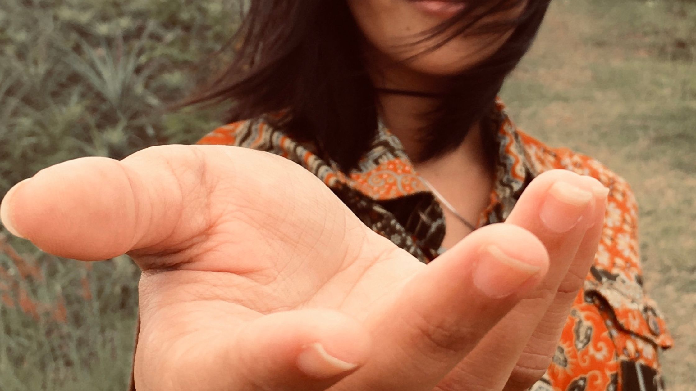 Outstretched hand offering an invitation, with a soft-focus person in the background, symbolizing connection, healing, and sacred community.